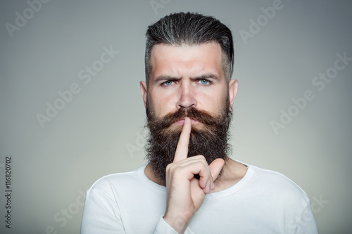 Bearded man with hush gesture photo