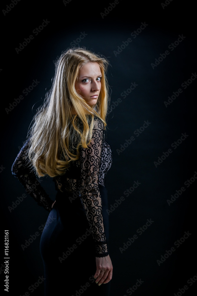 blonde girl on a black background in a dark guipure dress blonde girl on a black background in a dark guipure dress