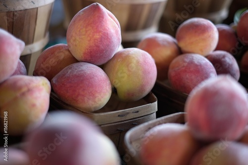 Fresh Peaches in Wooden Baskets at Farmers Market