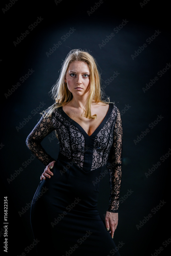 blonde girl on a black background in a dark guipure dress blonde girl on a black background in a dark guipure dress