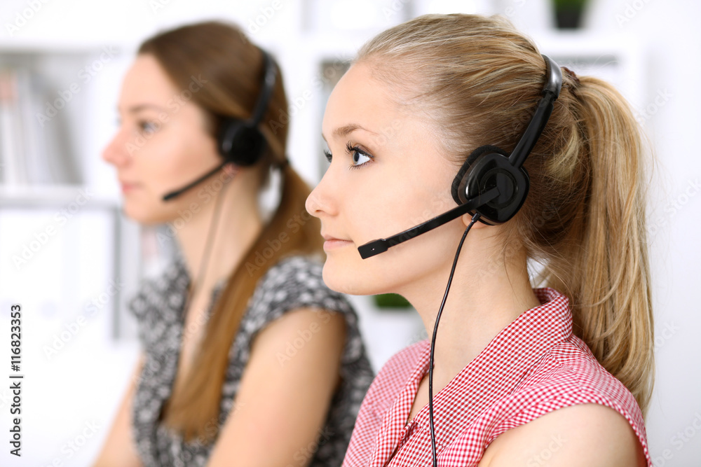 Call center. Focus on beautiful woman in headset Call center. Focus on beautiful woman in headset