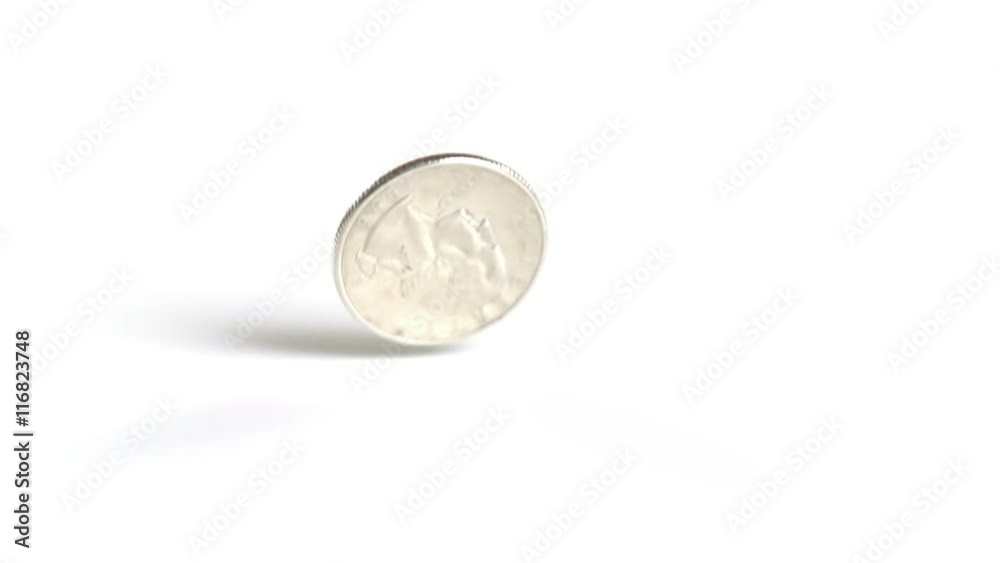 A United States quarter dollar coin falls and bounces onto a white surface. Shot with a high-speed camera. A United States quarter dollar coin falls and bounces onto a white surface. Shot with a high-speed camera.