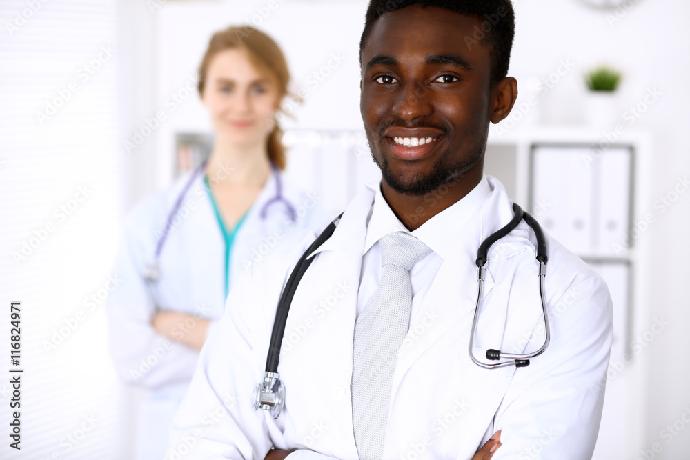 Happy african american male doctor with medical staff at the hospital Happy african american male doctor with medical staff at the hospital