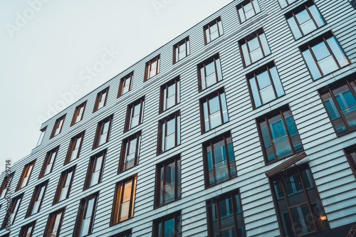 Light colored paneling on side of apartments