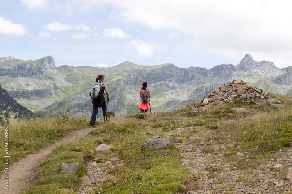 Two girls walking in the high of a mountain in Pyrenees, France