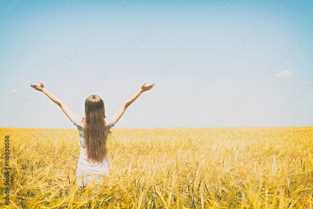 Young woman enjoying nature and sunlight in wheat field Young woman enjoying nature and sunlight in wheat field