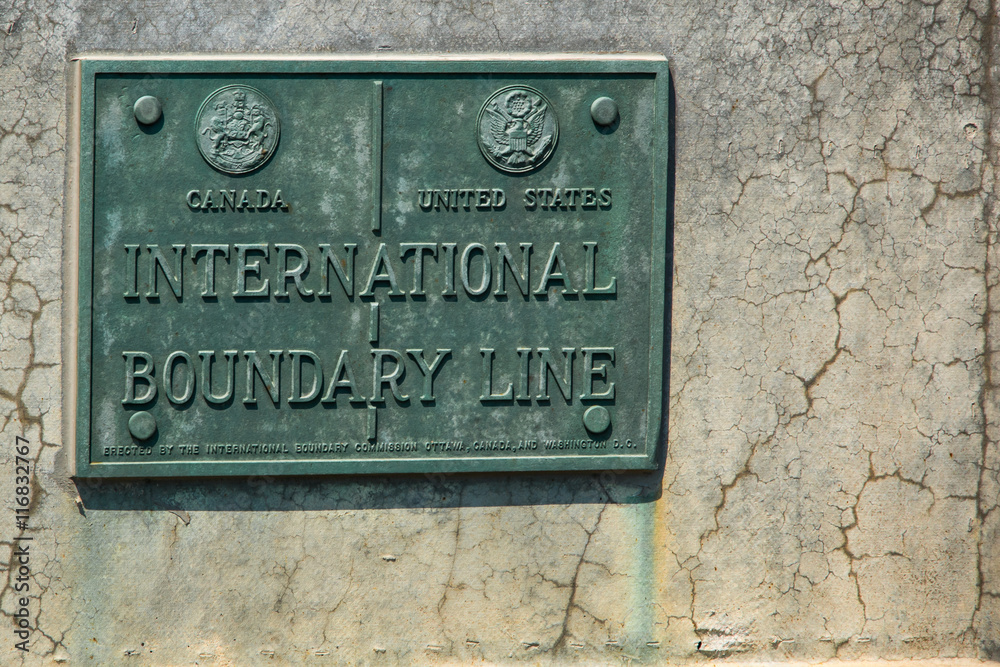 International Boundary Line Canada USA. Plaque indicating the international boundary line between the United States and Canada. Between New York state and the province of Ontario.