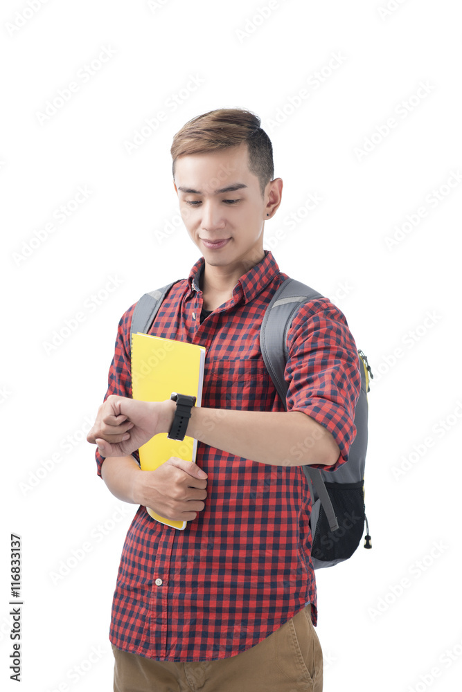 Portrait of a smiling student looking on wrist watch over white Portrait of a smiling student looking on wrist watch over white