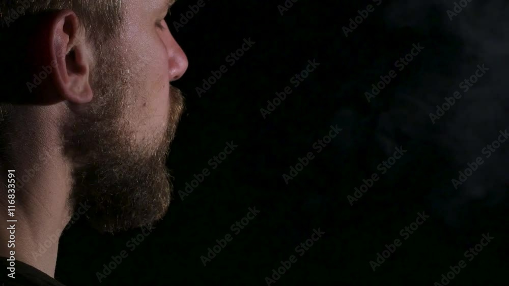 Video as a man smokes a big cigar. Black. Close up Video as a man smokes a big cigar. Black. Close up