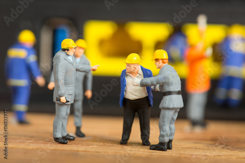 Technician workers repair and discussing connection maintanance with miniature human