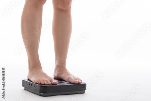 Women standing on weight scale and measure belt 