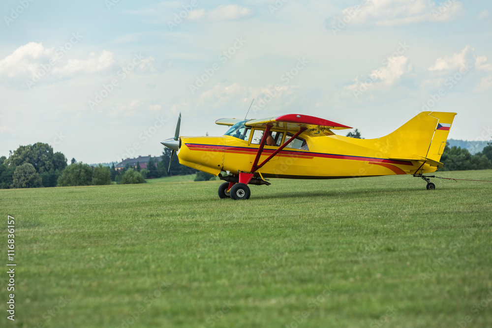 Towing aircraft on a grassy airport ready for takeoff Towing aircraft on a grassy airport ready for takeoff
