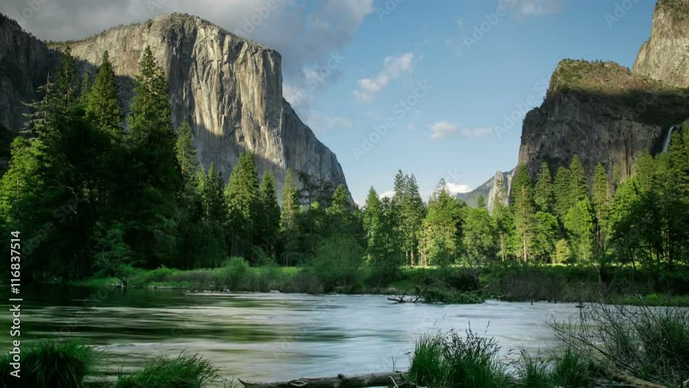 Merced River In Yosemite National Park. El Capitan and Half Dome are in the background. Merced River In Yosemite National Park. El Capitan and Half Dome are in the background.