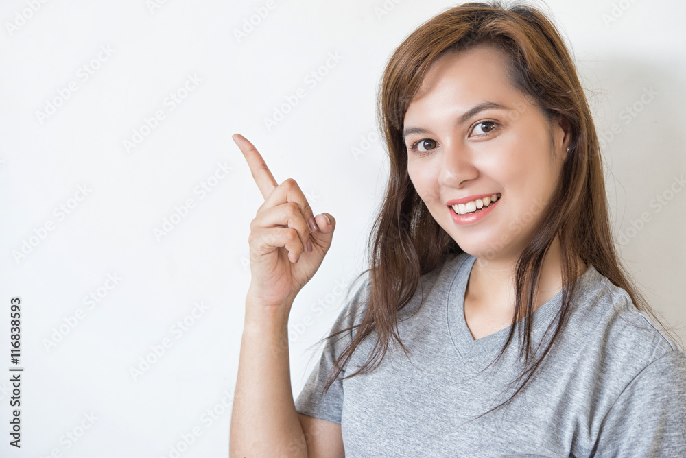 Young Asian business woman pointing index on free space. Young Asian business woman pointing index on free space.