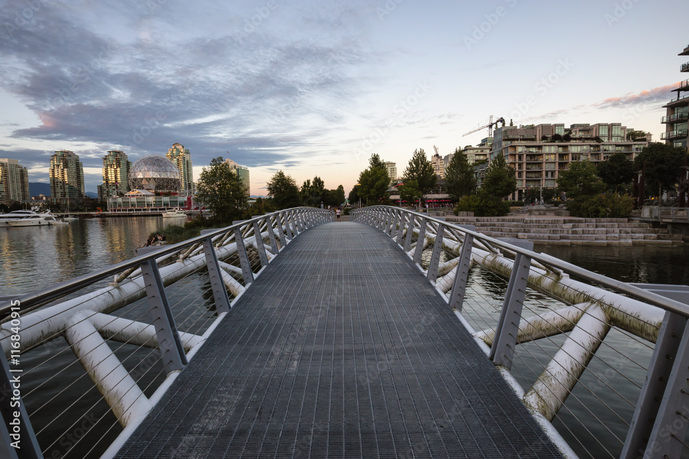 Pedestrian Bridge in False Creek. Taken in Downtown Vancouver, BC, Canada, during a cloudy sunset.