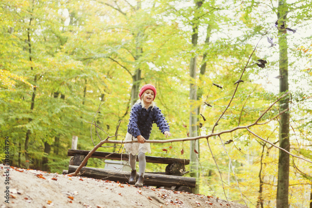 Happy girl carrying tree in forest Happy girl carrying tree in forest
