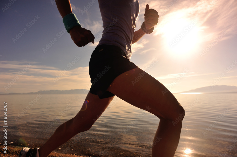 Φωτογραφία healthy young fitness woman runner running on sunrise seaside trail