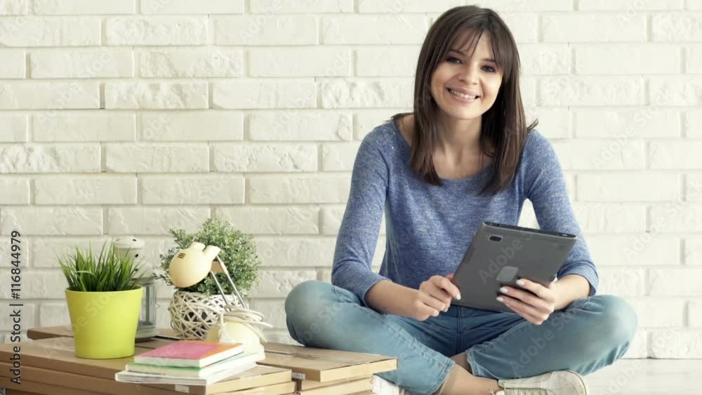 Portrait of happy, young woman with tablet sitting on floor at her new home
Portrait of happy, young woman with tablet sitting on floor at her new home