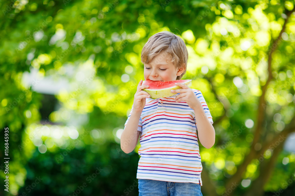 little preschool kid boy eating watermelon in summer little preschool kid boy eating watermelon in summer