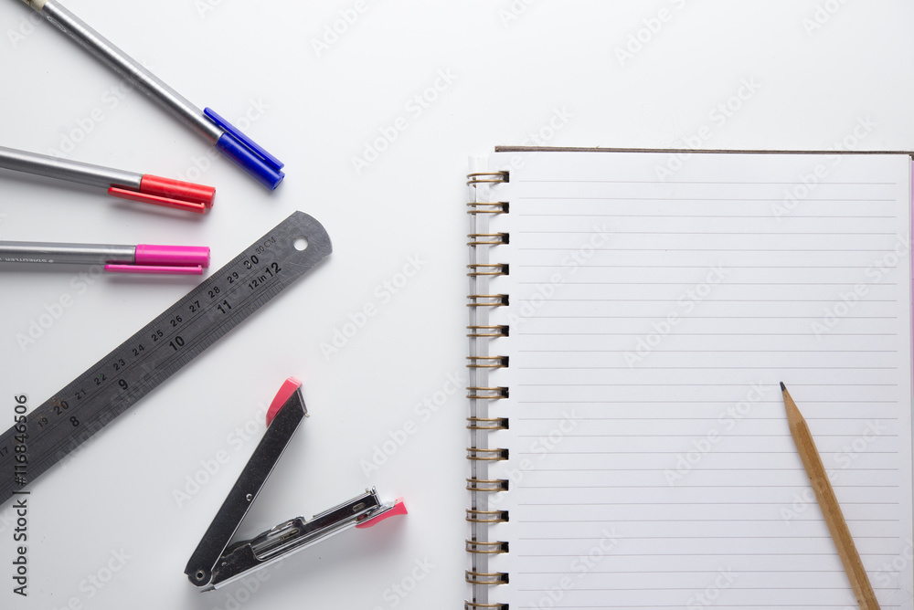 notebook pencil ruler and stapler on white background notebook pencil ruler and stapler on white background