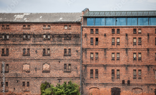 wall of the old factory building of red brick with narrow windows