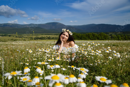 Beautiful woman on a flower granden enjoying her time outdoors