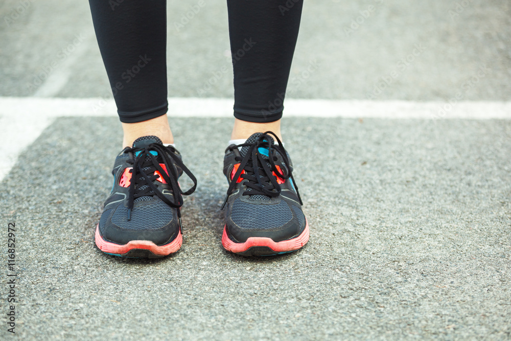 Close up of running shoes on road.