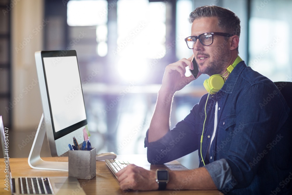 Man talking on phone in office Man talking on phone in office