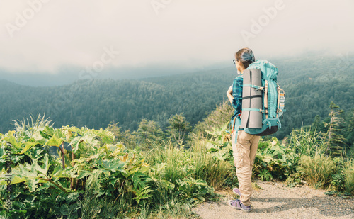 Hiker woman looking at the mountains in summer