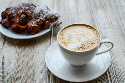 Fototapeta Naklejka Na Ścianę i Meble -  Delicious breakfast : cappuccino coffe cup served with almond croissant on grey background.