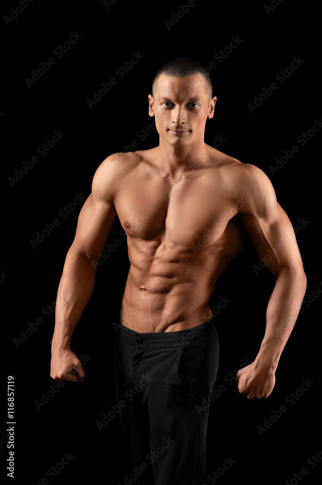 Muscular fitness man on black background