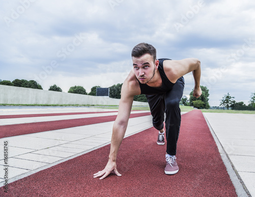 Athlete preparing for training or competitions on running track © pavelgulea