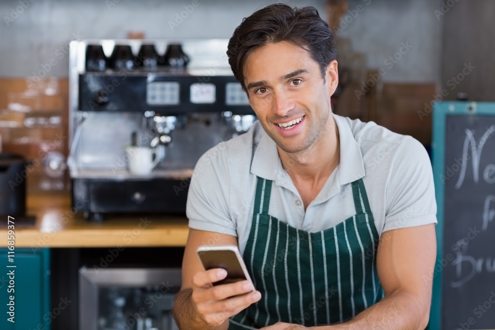 Portrait of smiling waitress using mobile phone Portrait of smiling waitress using mobile phone