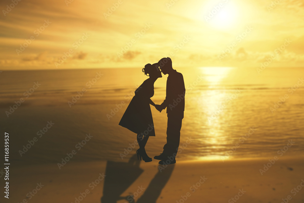 silhouette beautiful young couple posing at sunset in the sea