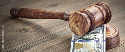 Judges or Auctioneers Gavel And Money Stack On Wooden Background