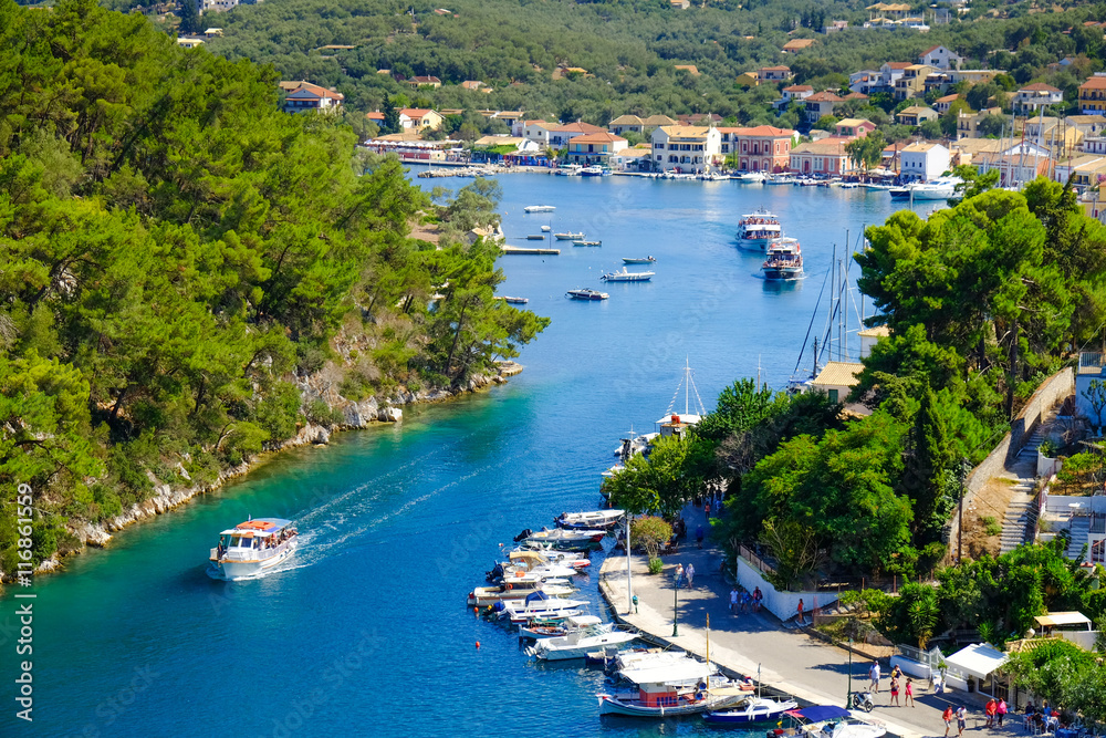 Old harbour of Paxos island with boat entering the grand canal