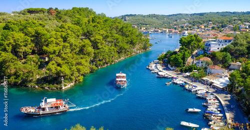 Paxos island panorama with boat entering the grand canal photo