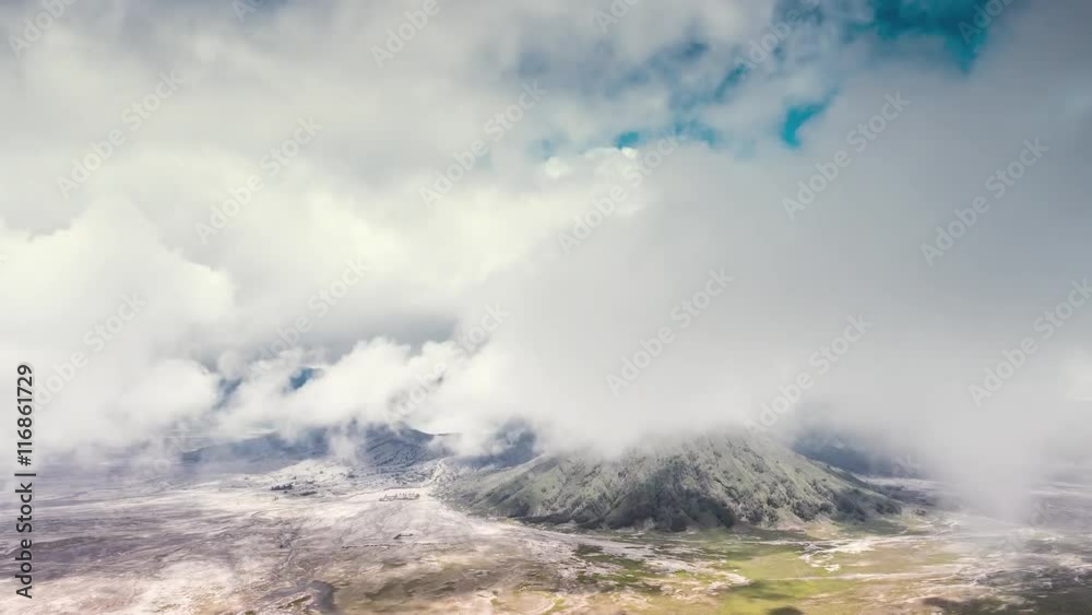 Aerial view through clouds of unique volcanic landscape of mountain Bromo , Java Aerial view through clouds of unique volcanic landscape of mountain Bromo , Java