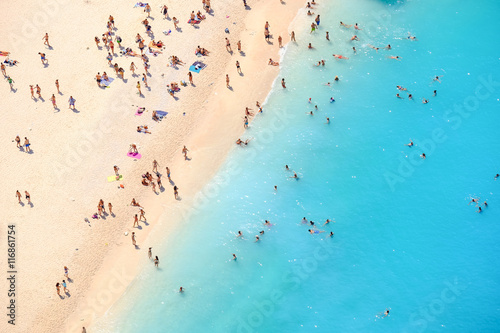 Tourists on the sand beach of Navagio Zakynthos Greece. People b