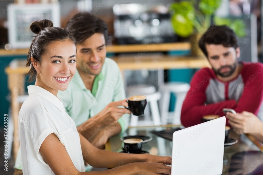 Portrait of woman using laptop in cafe Portrait of woman using laptop in cafe