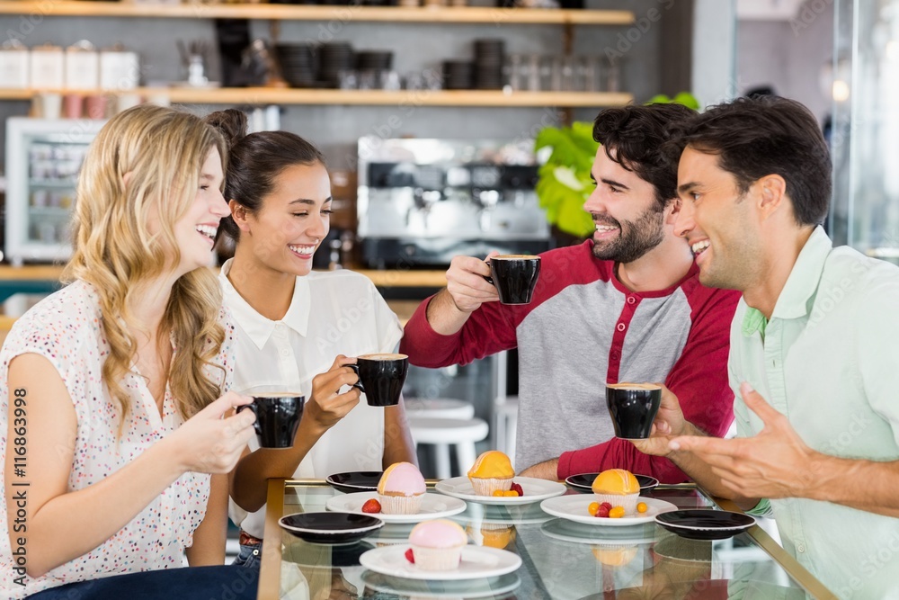 Group of friends having cup of coffee together