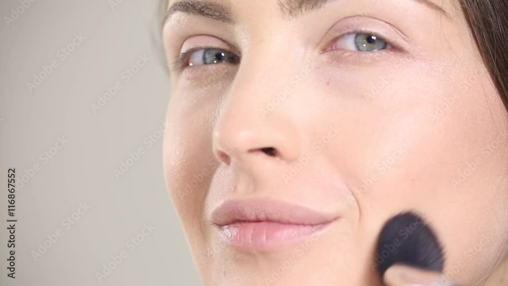 young beautiful perfect model applying professional makeup