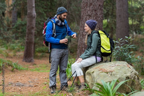 Hiker couple interacting with each other in forest