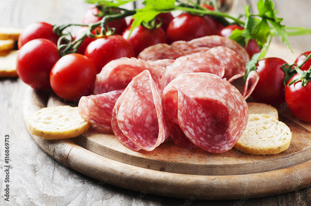 Fresh salami with tomato and bread