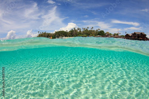 Tropical island and ocean split image half and half over under photo