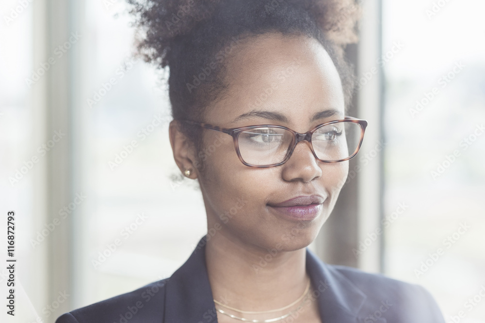 Portrait of smiling businesswoman looking through window Portrait of smiling businesswoman looking through window