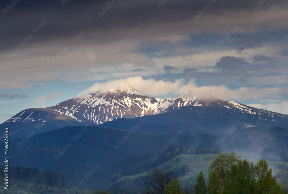 Mountain snow peak in carpathian with dramatic sky