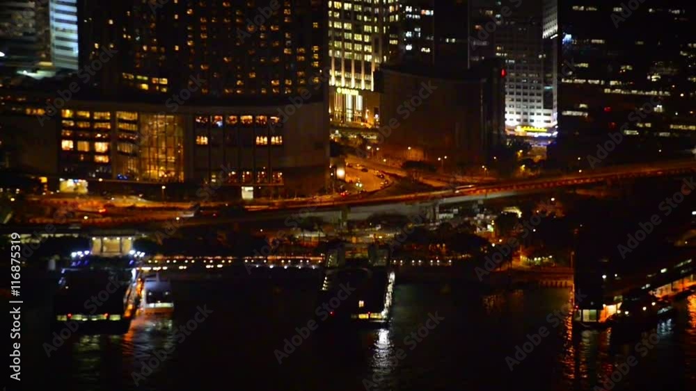 FullHD video - Beautiful and colorful lights of a major city at night, with contemporary highrise buildings, fronted by a busy harbor. FullHD video - Beautiful and colorful lights of a major city at night, with contemporary highrise buildings, fronted by a busy harbor.