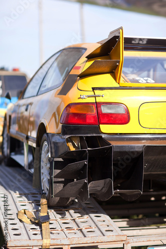 Rearlights of yellow sport car with black diffuser photo