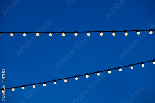 string light bulb hanging for decorative night party and blue sky background